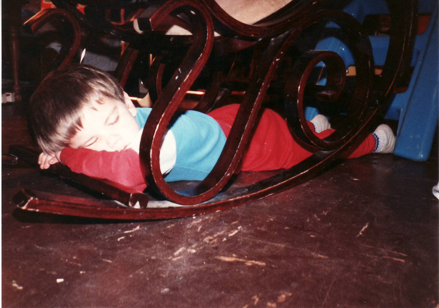 Kirby Dodd age five asleep under a rocking chair