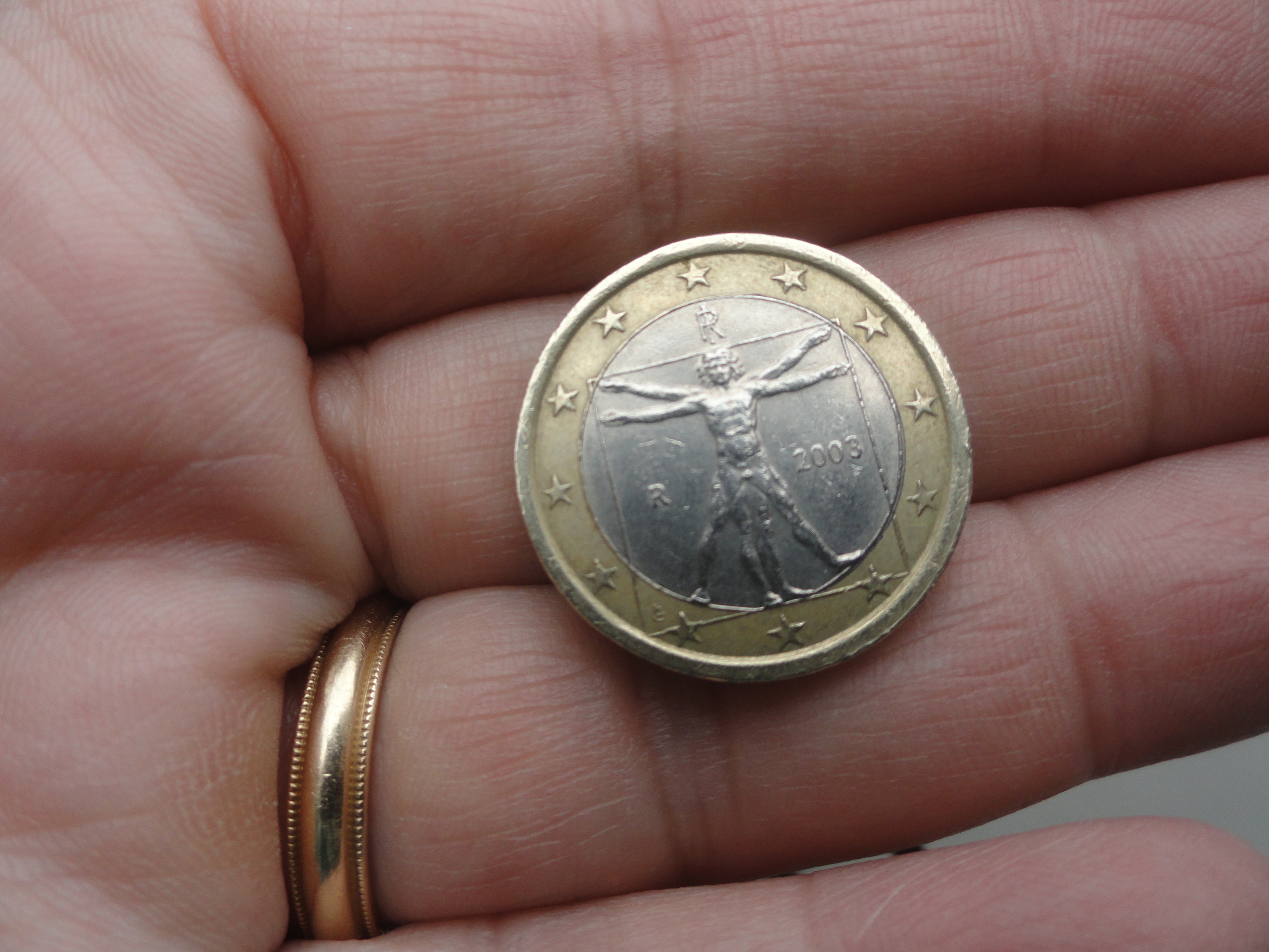  a Euro coin with Vetruvian Man on it