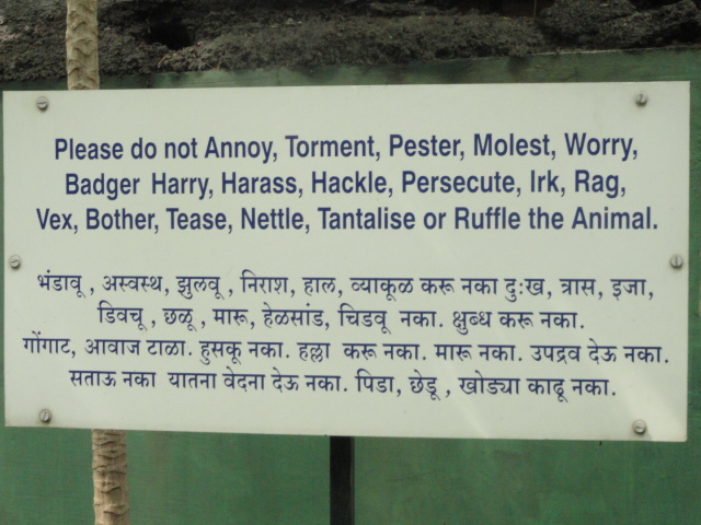 zoo sign in Hindi and English telling people not to bother the animal