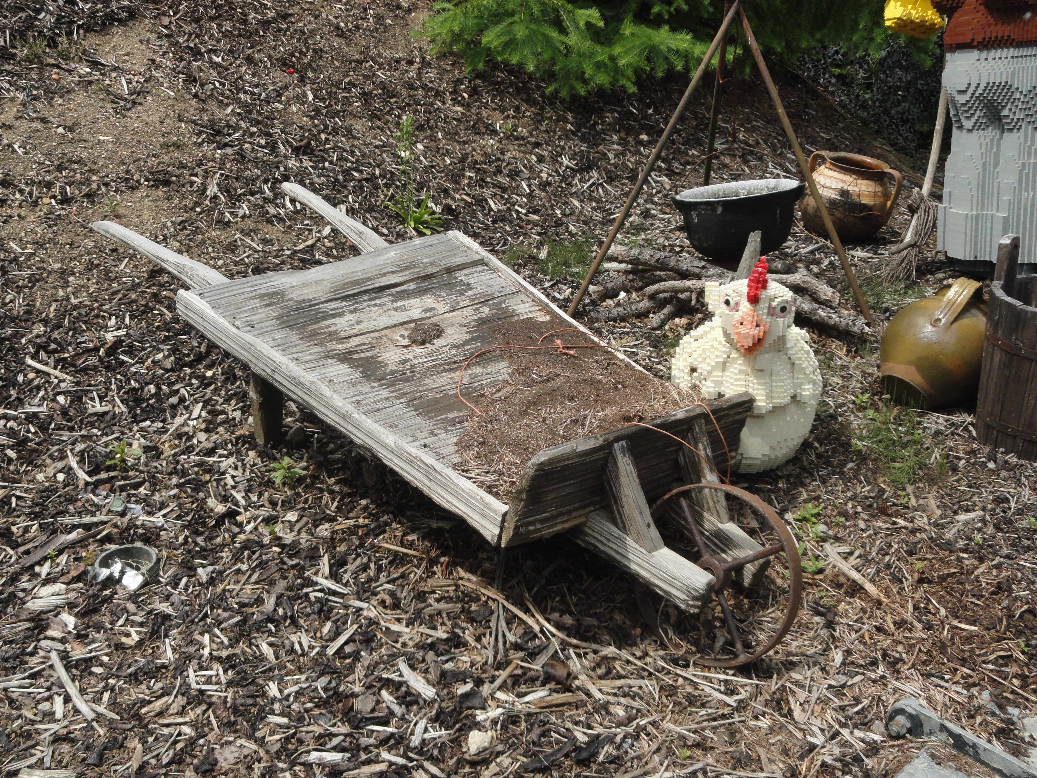 antique wheelbarrow, next to a fullsized chicken made of Lego, at LegoLand Windsor