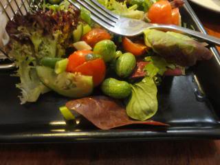 salad on square black plate, with fork