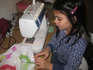  child sewing with sewing machine