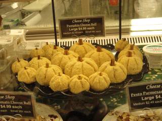 small cheese balls shaped like pumpkins, in a store display